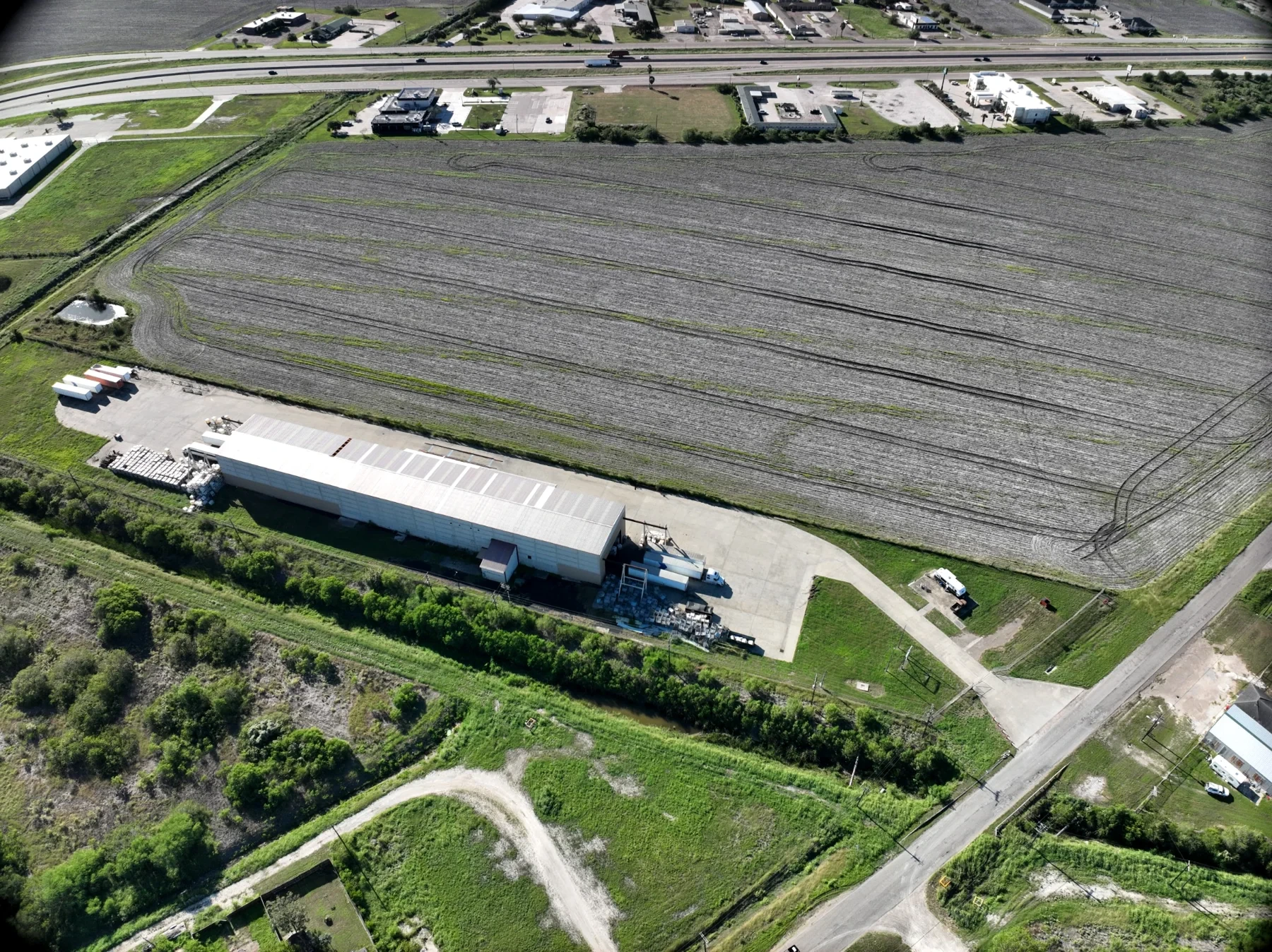 Aerial view of warehouse, concrete yard and driveway